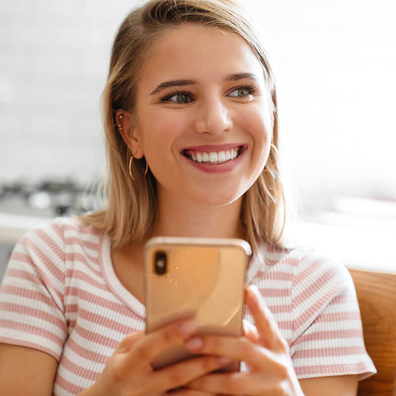 Smiling Lady holding a mobile phone